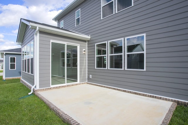 back of house featuring a yard and a patio