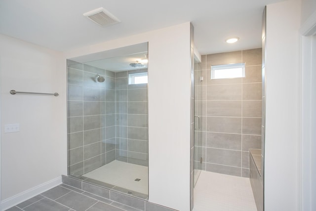 bathroom with visible vents, a shower stall, baseboards, and tile patterned floors