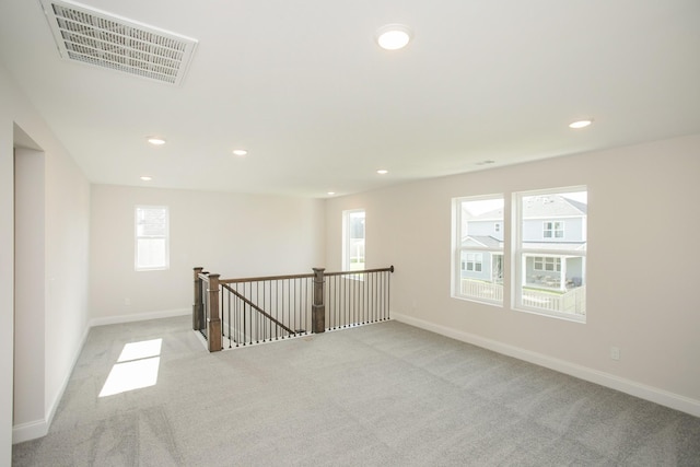 unfurnished room featuring light carpet, baseboards, visible vents, and recessed lighting