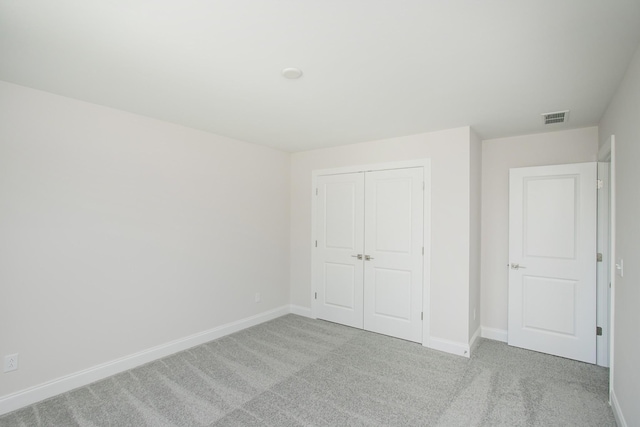 unfurnished bedroom featuring baseboards, visible vents, and carpet flooring