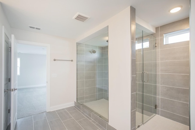 full bathroom featuring a shower stall, visible vents, baseboards, and tile patterned floors