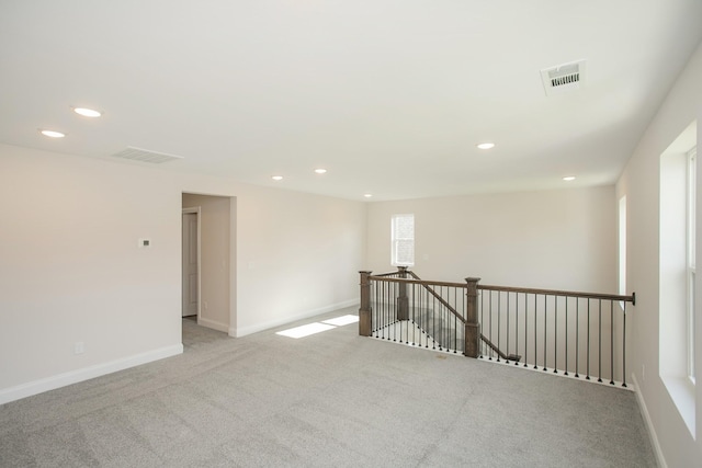 spare room with recessed lighting, visible vents, and baseboards