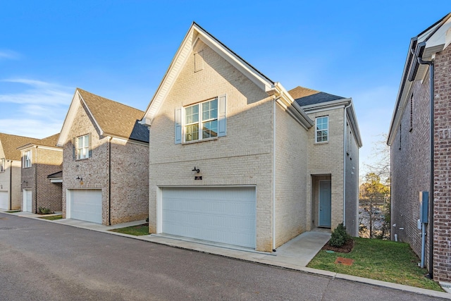 traditional-style house featuring brick siding and an attached garage