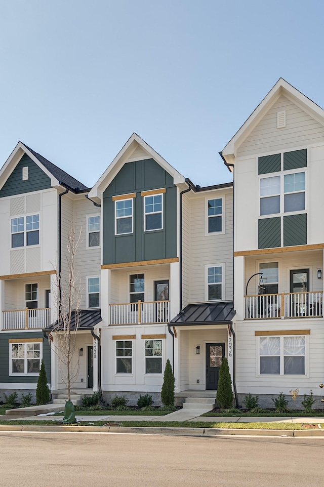 townhome / multi-family property featuring a standing seam roof, metal roof, and board and batten siding