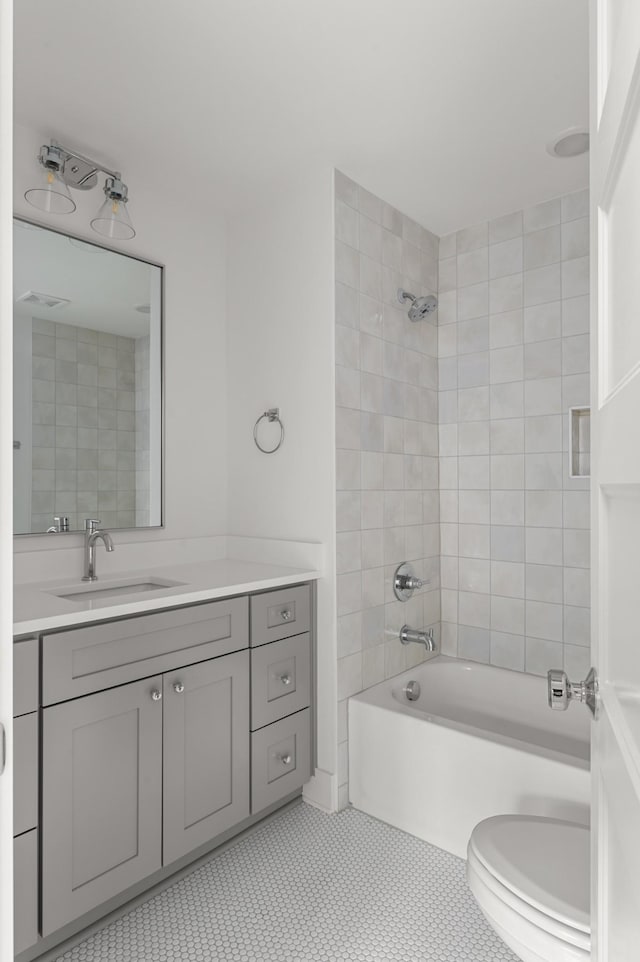 full bath with visible vents, shower / bath combination, vanity, and toilet