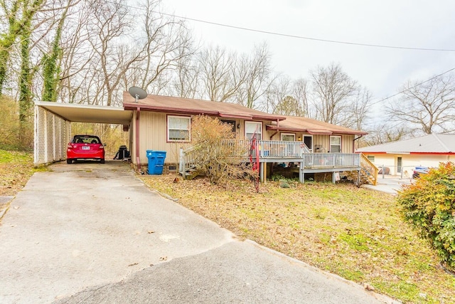 view of front facade with crawl space, a porch, a carport, and concrete driveway