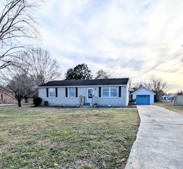 view of front facade with a garage, a front yard, concrete driveway, and an outdoor structure