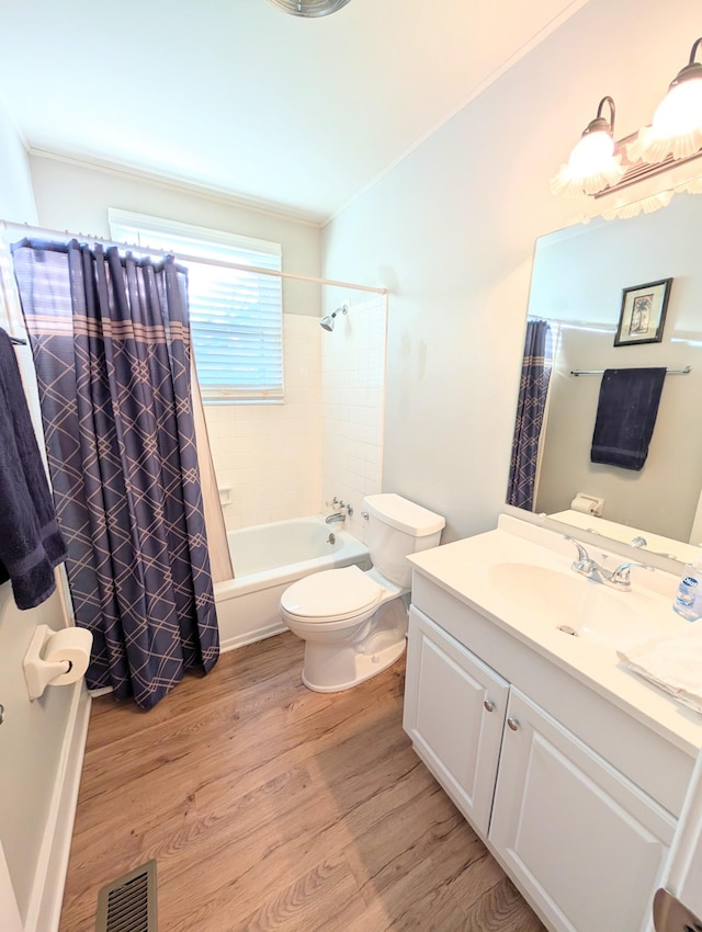 bathroom with shower / bath combination with curtain, visible vents, toilet, vanity, and wood finished floors