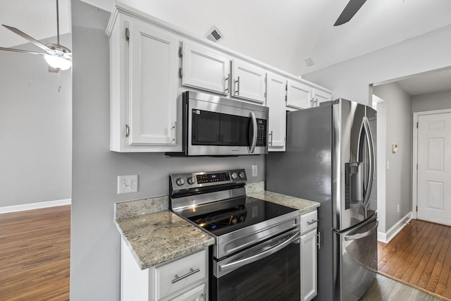 kitchen with white cabinetry, hardwood / wood-style flooring, a ceiling fan, and appliances with stainless steel finishes