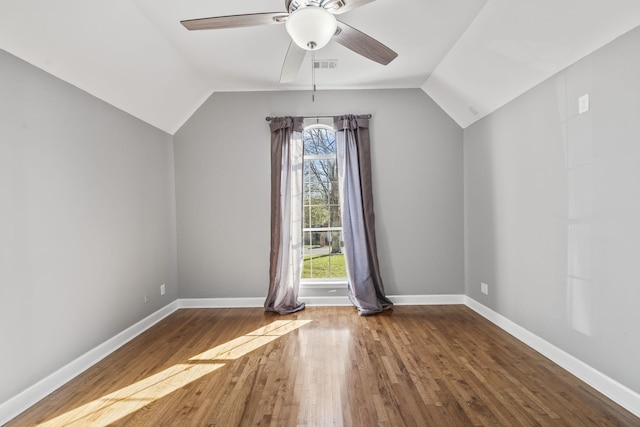 bonus room with a wealth of natural light, visible vents, lofted ceiling, and wood finished floors