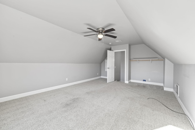 bonus room featuring visible vents, baseboards, ceiling fan, vaulted ceiling, and light carpet