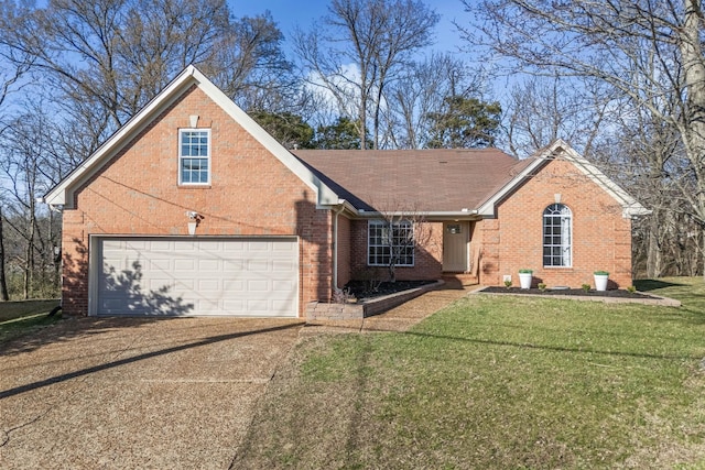 view of front of home featuring driveway, roof with shingles, a front yard, a garage, and brick siding