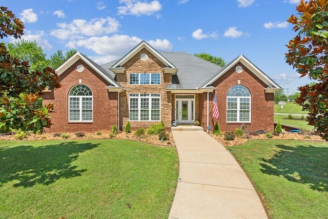 view of front facade featuring a front lawn and brick siding