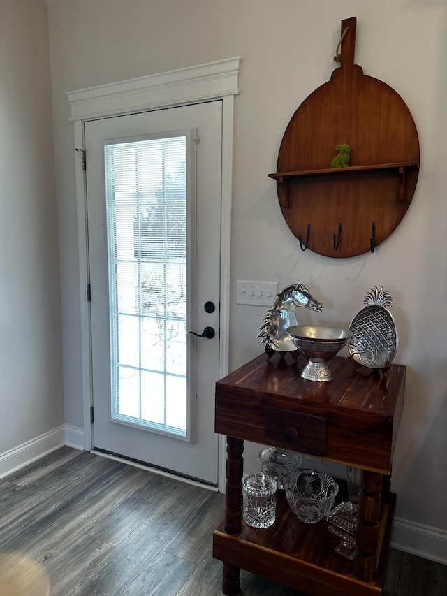 entryway with baseboards, a wealth of natural light, and wood finished floors