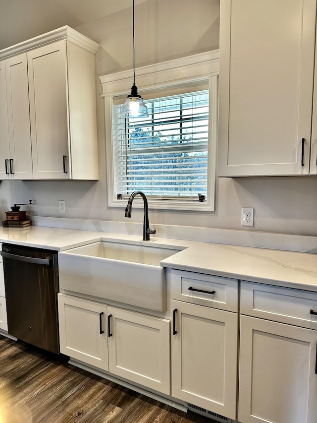 kitchen with dark wood-style flooring, decorative light fixtures, stainless steel dishwasher, white cabinetry, and a sink