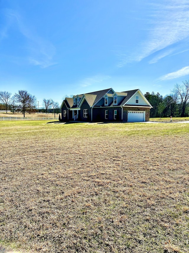 view of front of property with a garage and a front yard