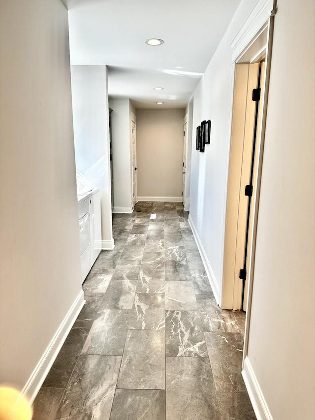 corridor featuring baseboards and recessed lighting