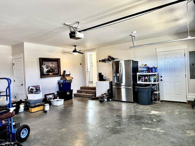 garage with stainless steel fridge, electric panel, and a garage door opener