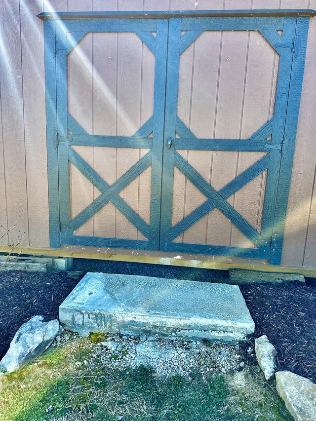 view of gate with an outdoor structure