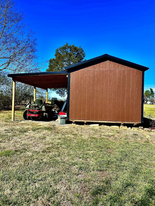 view of property exterior with a storage unit, a lawn, and an outdoor structure