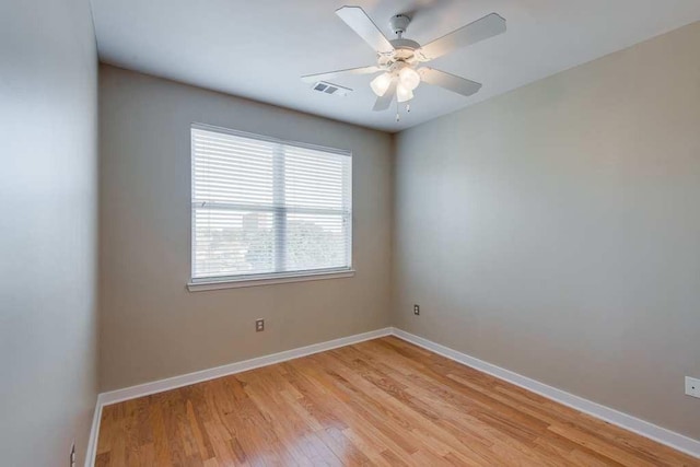 unfurnished room with a ceiling fan, baseboards, visible vents, and light wood finished floors