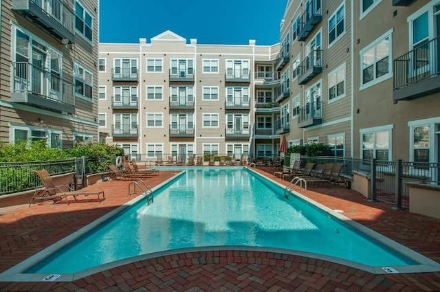 pool with fence and a patio