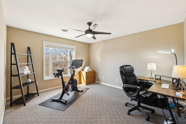 carpeted office space featuring visible vents, ceiling fan, and baseboards