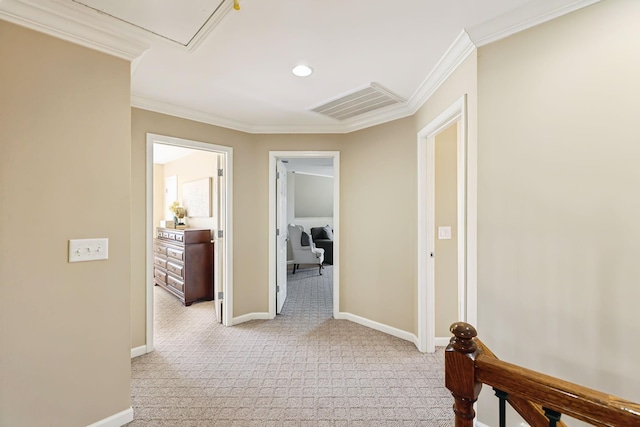 corridor featuring light carpet, baseboards, visible vents, and ornamental molding