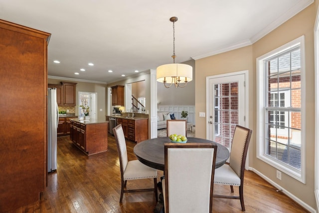 dining space with baseboards, dark wood finished floors, crown molding, and recessed lighting