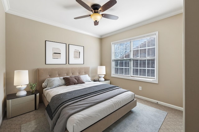 carpeted bedroom featuring baseboards, a ceiling fan, and crown molding