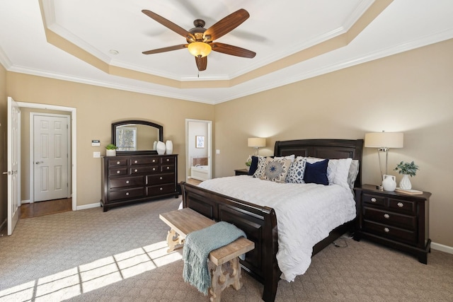 carpeted bedroom with a raised ceiling, crown molding, and baseboards