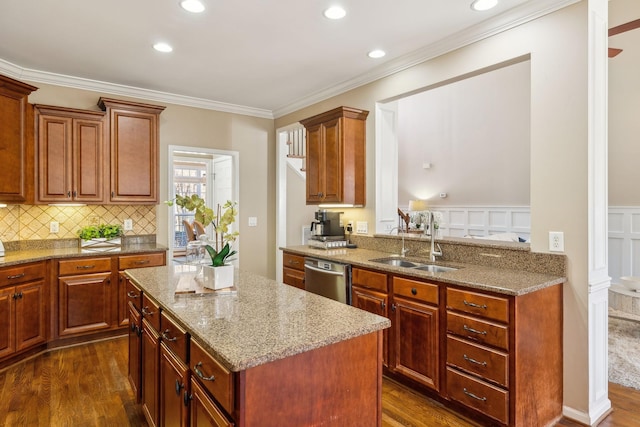 kitchen with dark wood-style flooring, a sink, stainless steel dishwasher, and light stone countertops