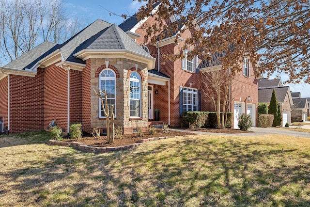 view of front of house with a front yard, stone siding, and brick siding