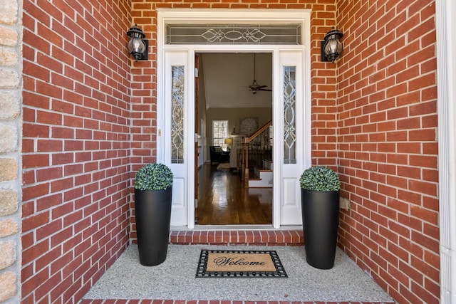 doorway to property featuring brick siding