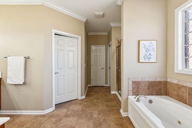 bathroom with a stall shower, crown molding, baseboards, and a bath