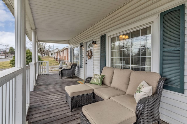 deck with covered porch and an outdoor living space