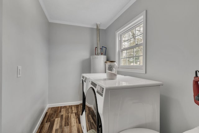 clothes washing area with baseboards, dark wood-style floors, washing machine and clothes dryer, crown molding, and gas water heater