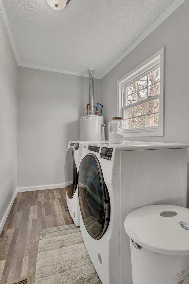 laundry room featuring a textured ceiling, gas water heater, laundry area, dark wood-style floors, and crown molding