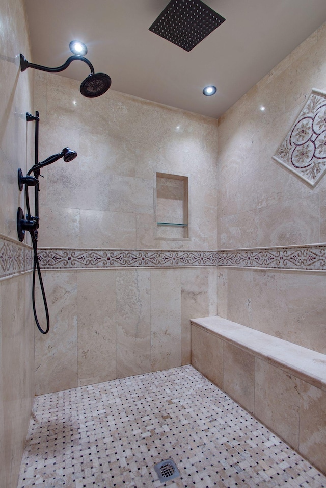 bathroom with recessed lighting and a tile shower