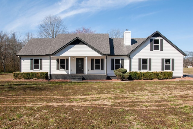 view of front of house with a porch, a front yard, roof with shingles, and a chimney