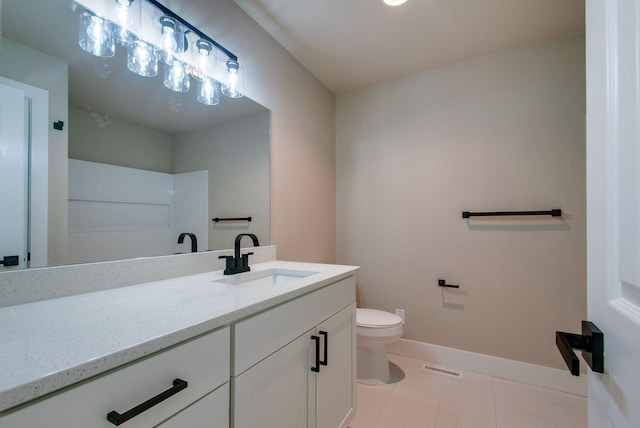 bathroom with visible vents, toilet, vanity, and baseboards