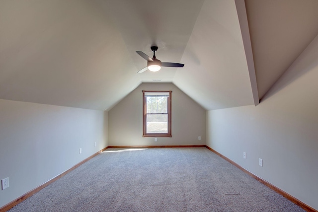 bonus room with lofted ceiling, carpet floors, a ceiling fan, and baseboards