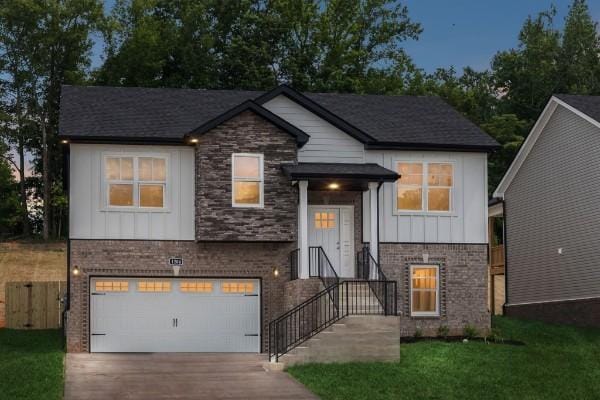 view of front facade featuring brick siding, an attached garage, board and batten siding, and driveway