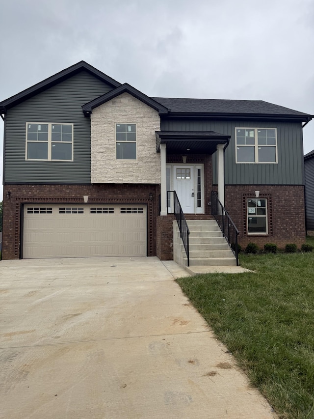 156 Cardinal Crk, Clarksville, TN 37040 - split foyer home with brick siding, a garage, board and batten siding, driveway, and a front yard