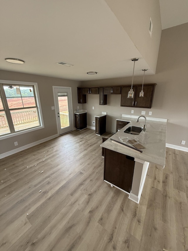 156 Cardinal Crk, Clarksville, TN 37040 - kitchen with a sink, dark brown cabinets, light wood-style flooring, and baseboards