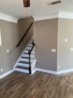 staircase featuring visible vents, crown molding, baseboards, and wood finished floors