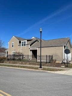 view of front of house featuring fence