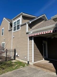 view of property exterior with a garage, fence, and driveway