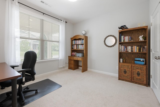 office featuring carpet, visible vents, and baseboards