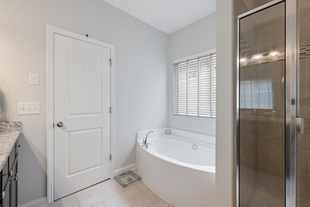 bathroom featuring baseboards, tile patterned floors, a garden tub, vanity, and a shower stall